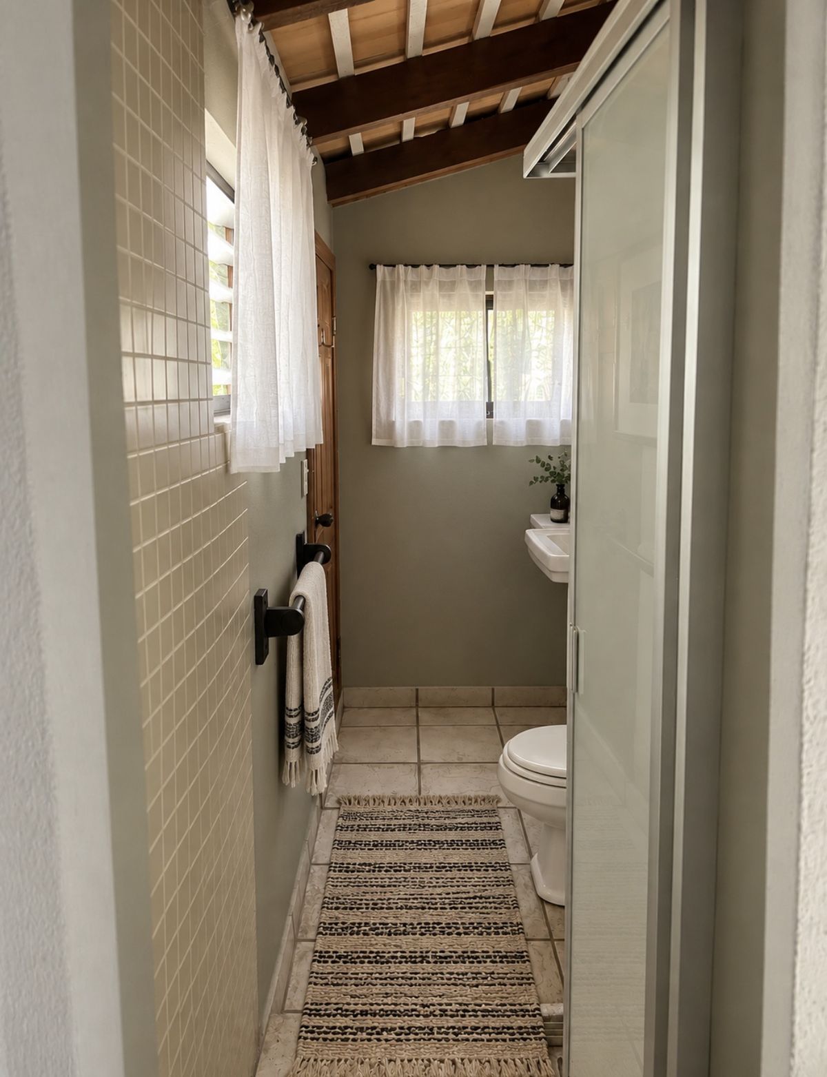 Mangrove Room private bathroom with a glass shower and wood-beamed ceiling