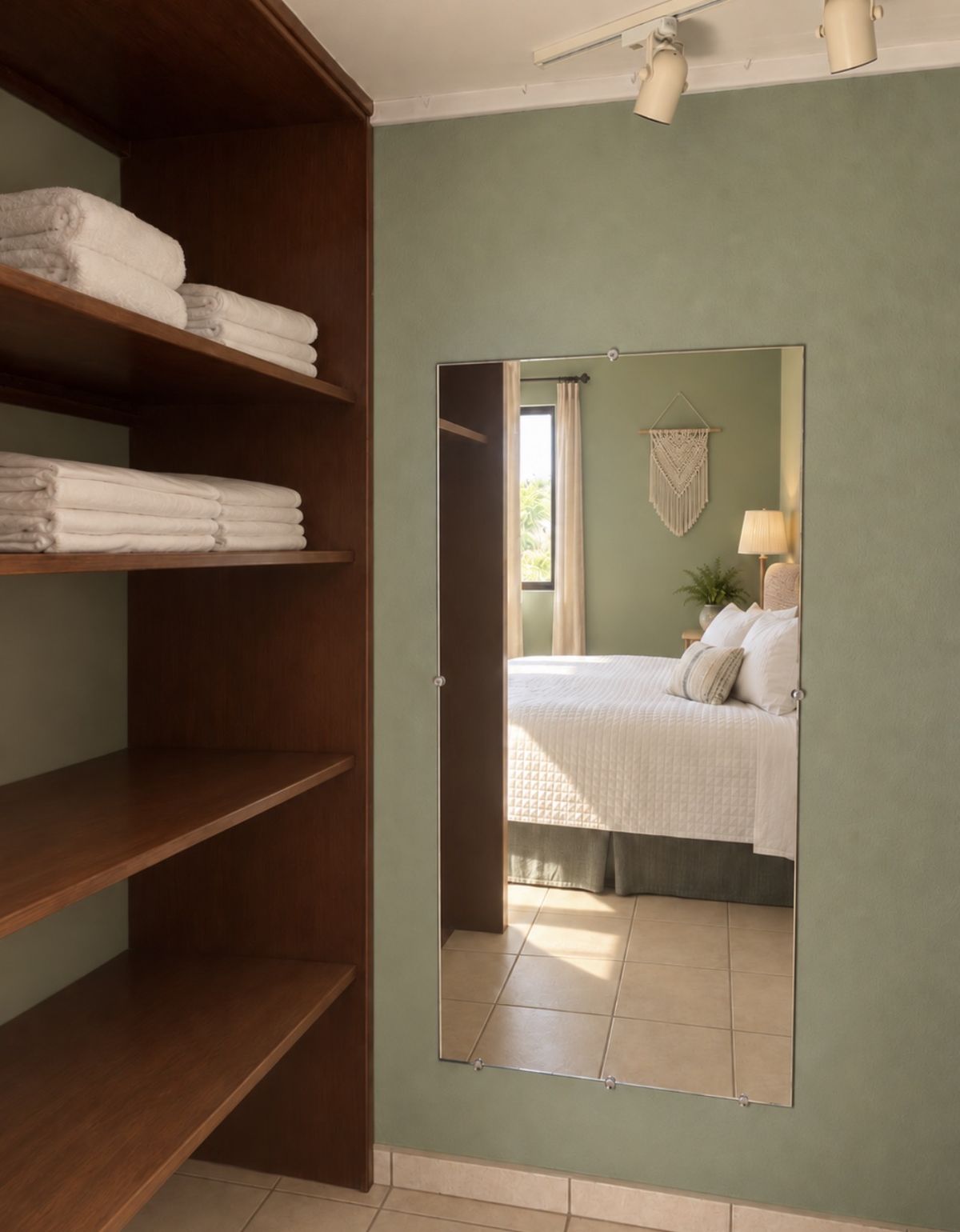 Mangrove Room closet with open wooden shelves stacked with towels