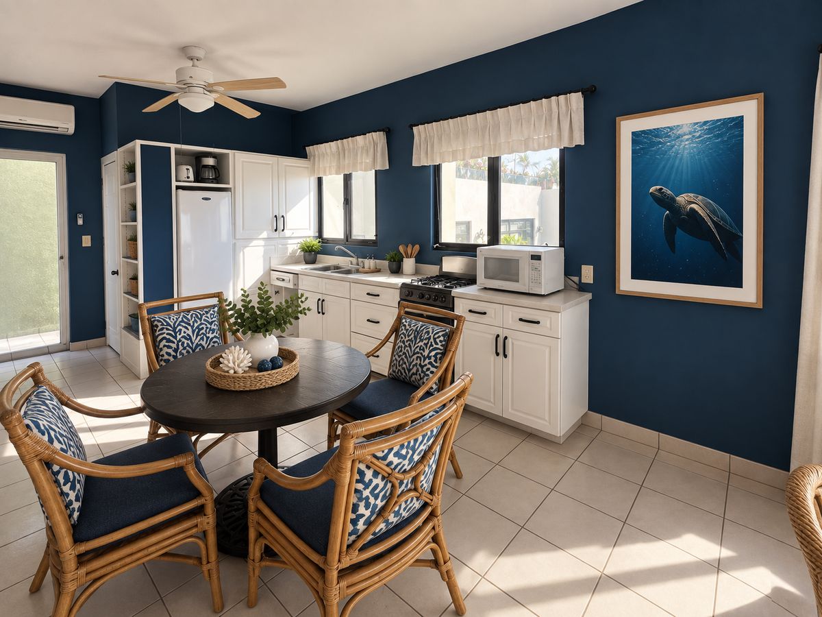 Ocean Suite kitchen with white cabinets, a gas range, a round dining table and a sea turtle print
