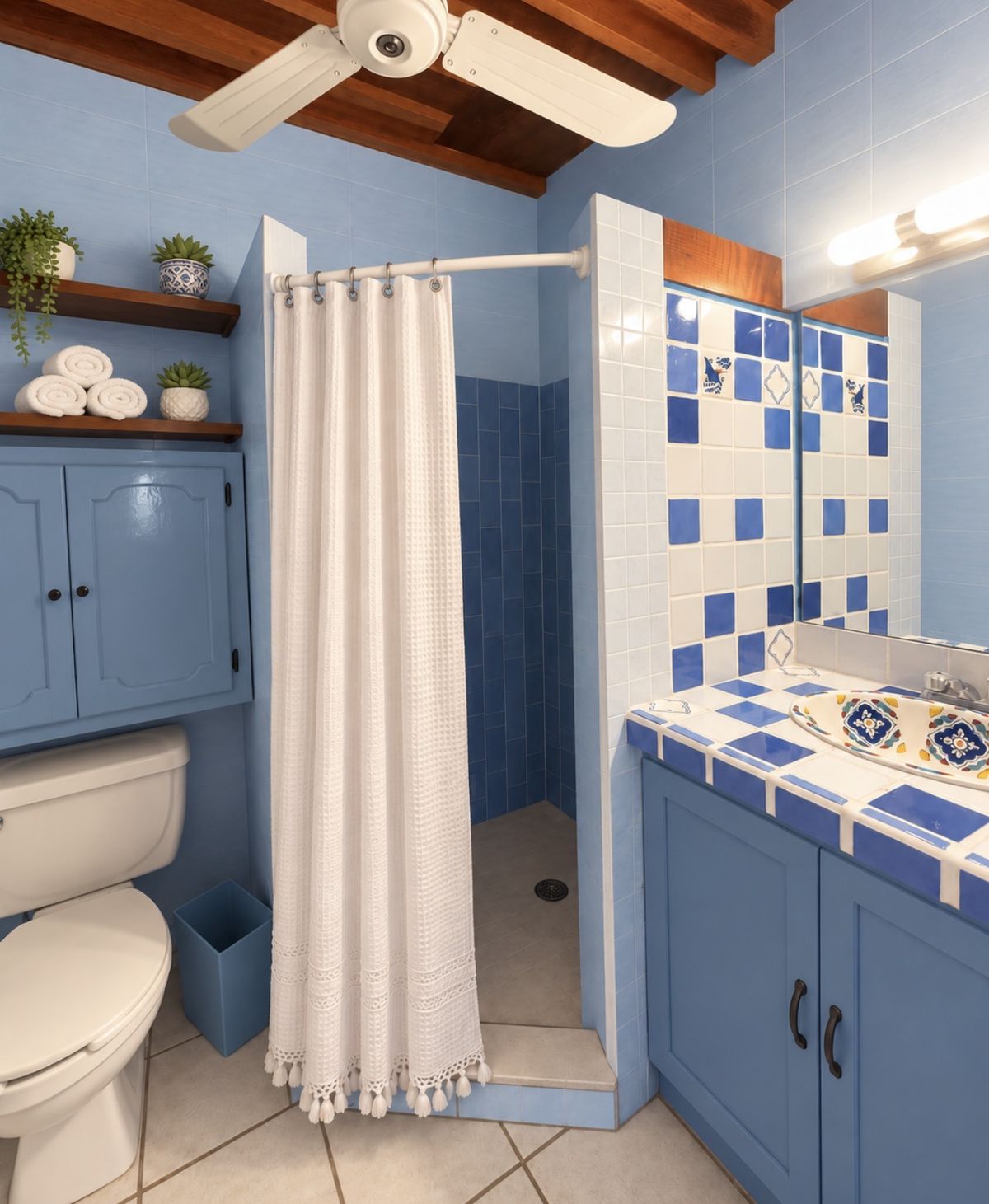 Wave Room private bathroom with blue and white tile, a walk-in shower and a wood-beamed ceiling